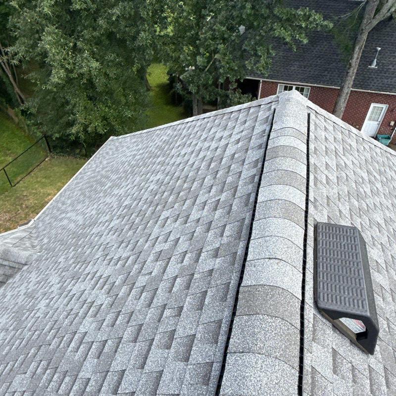 Asphalt shingle roof with ridge vent and step ladder