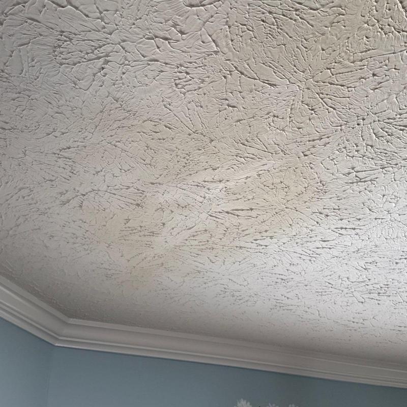 Popcorn ceiling texture with crown molding trim