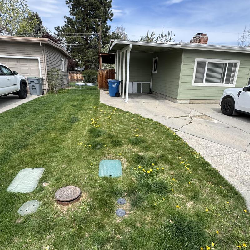 Water main access covers in residential lawn driveway Water main access covers in residential lawn driveway