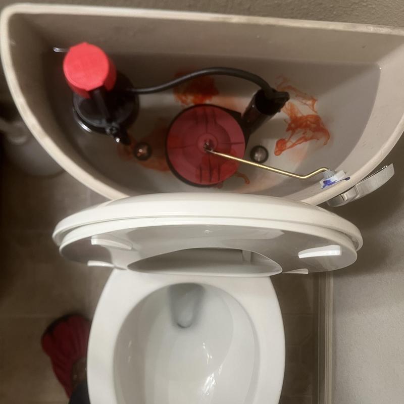 Toilet flush valve with red dye test inside tank