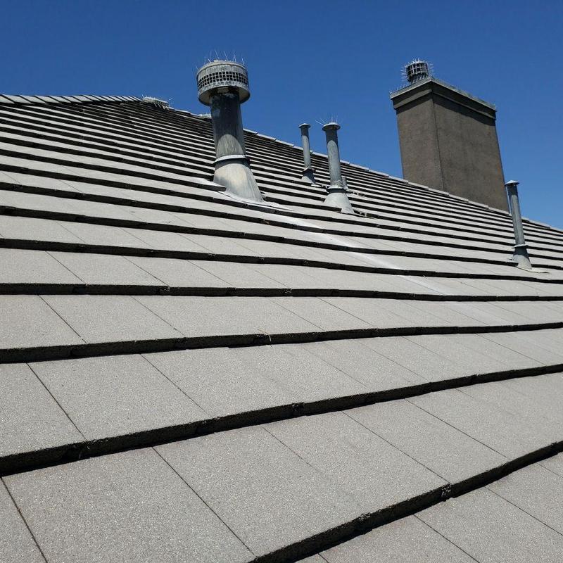 Tile roof with multiple pipe jacks and chimney flashing