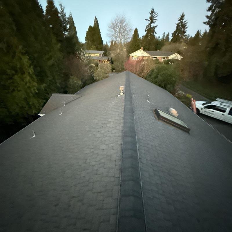 Ridge caps and shingles with new chimney flashing