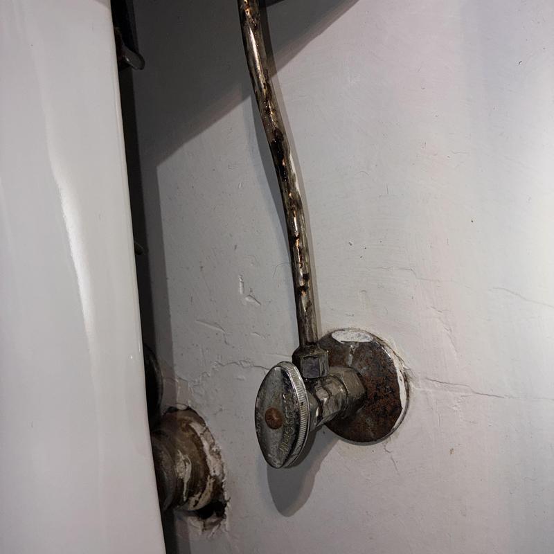 Angle stop valve with corroded supply line near toilet