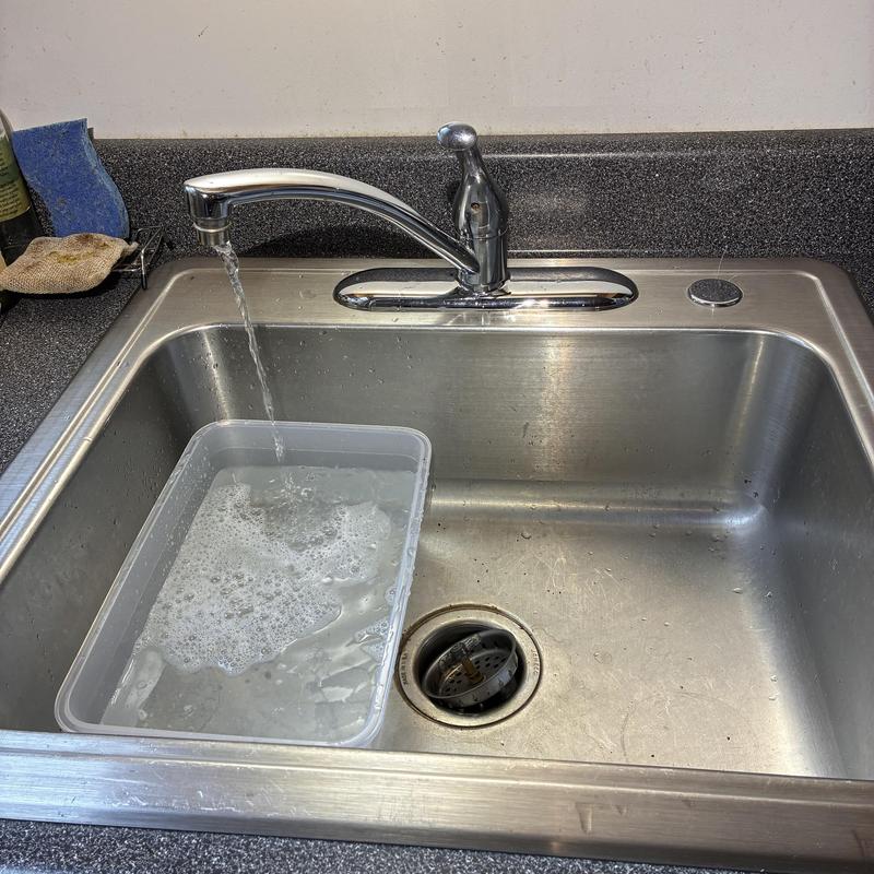 Kitchen sink faucet with running water and container