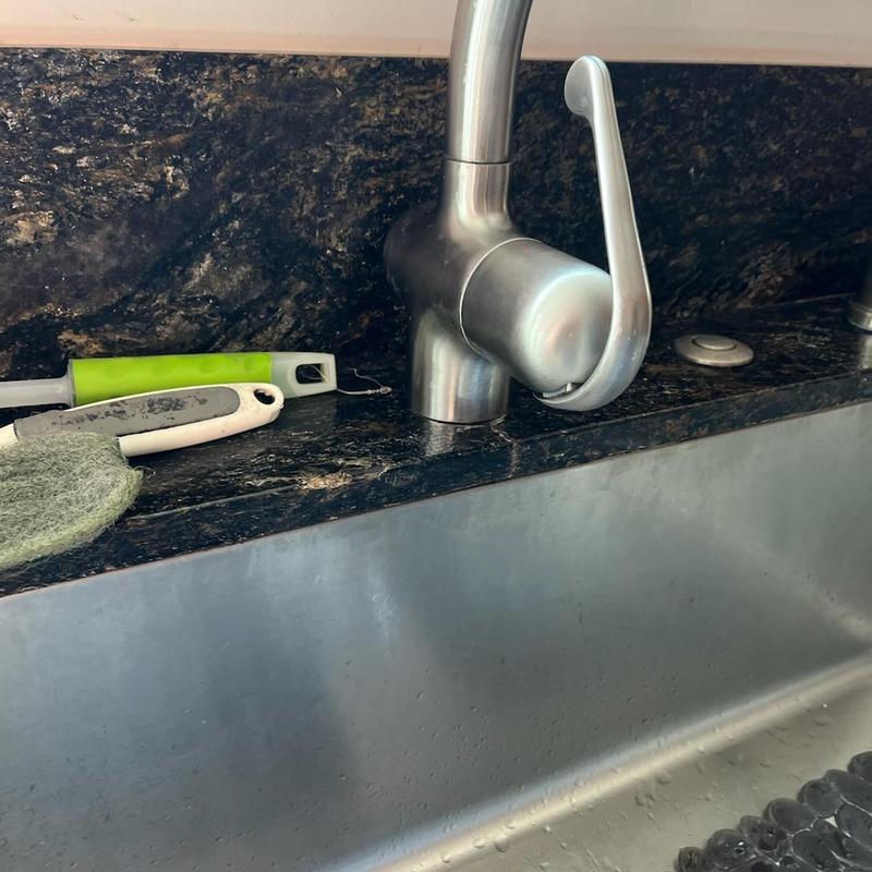 Kitchen faucet installed on granite countertop