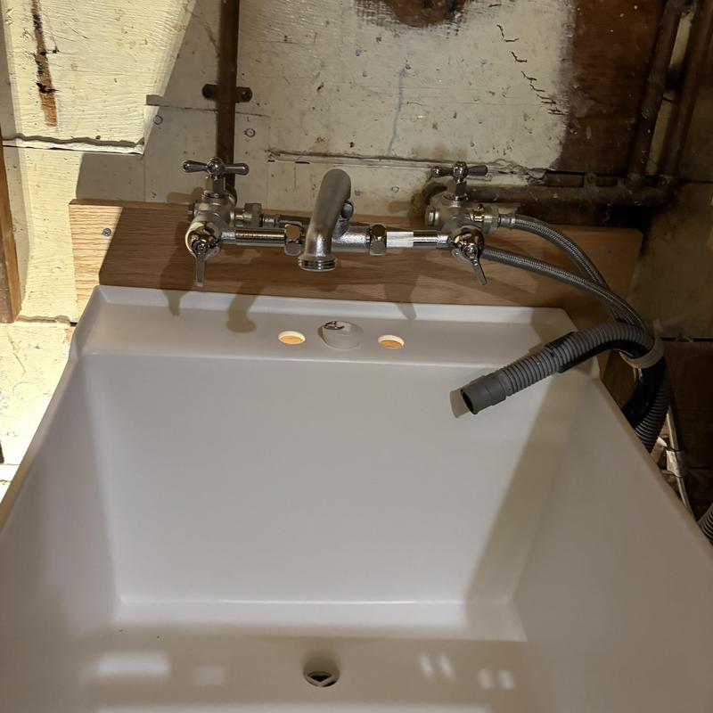 Laundry sink and faucet installation with plumbing hookups