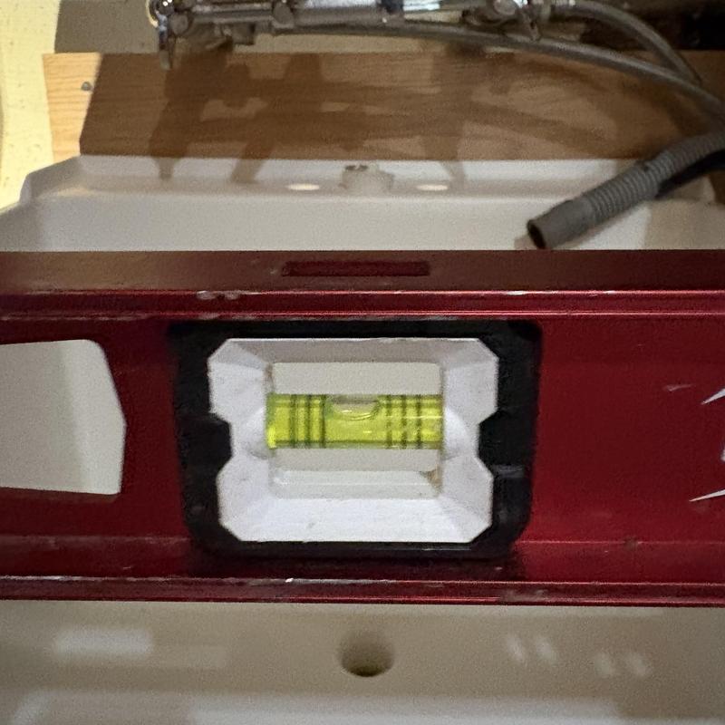 Laundry sink installation with level check and faucet