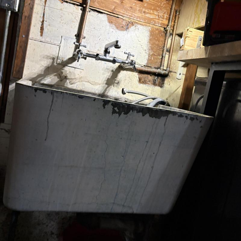 Laundry sink and faucet installation in utility room