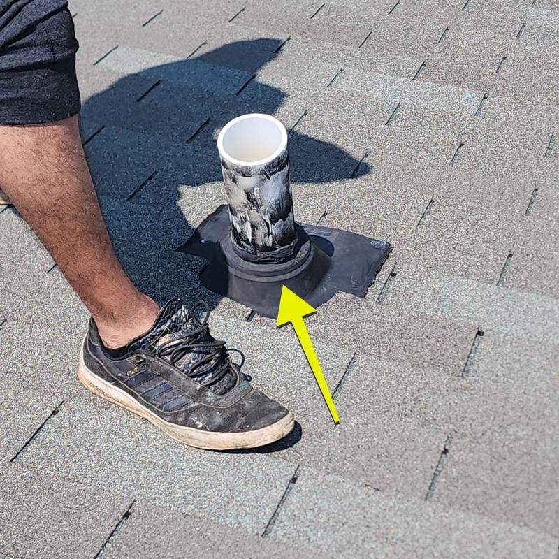 Roof vent pipe flashing with rubber seal on shingle roof