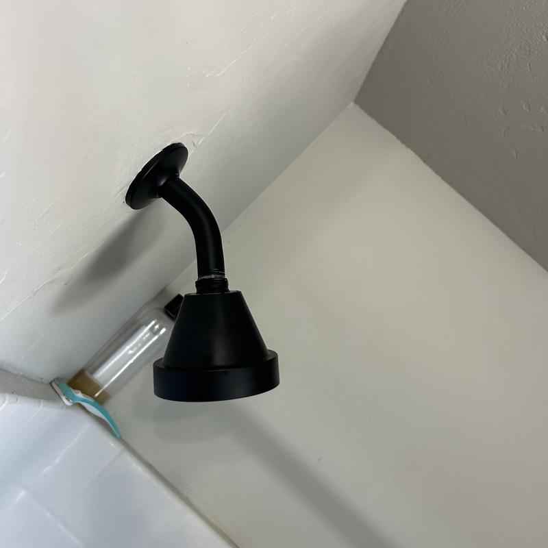 Shower head with cleared clog and restored pressure Shower head with cleared clog and restored pressure