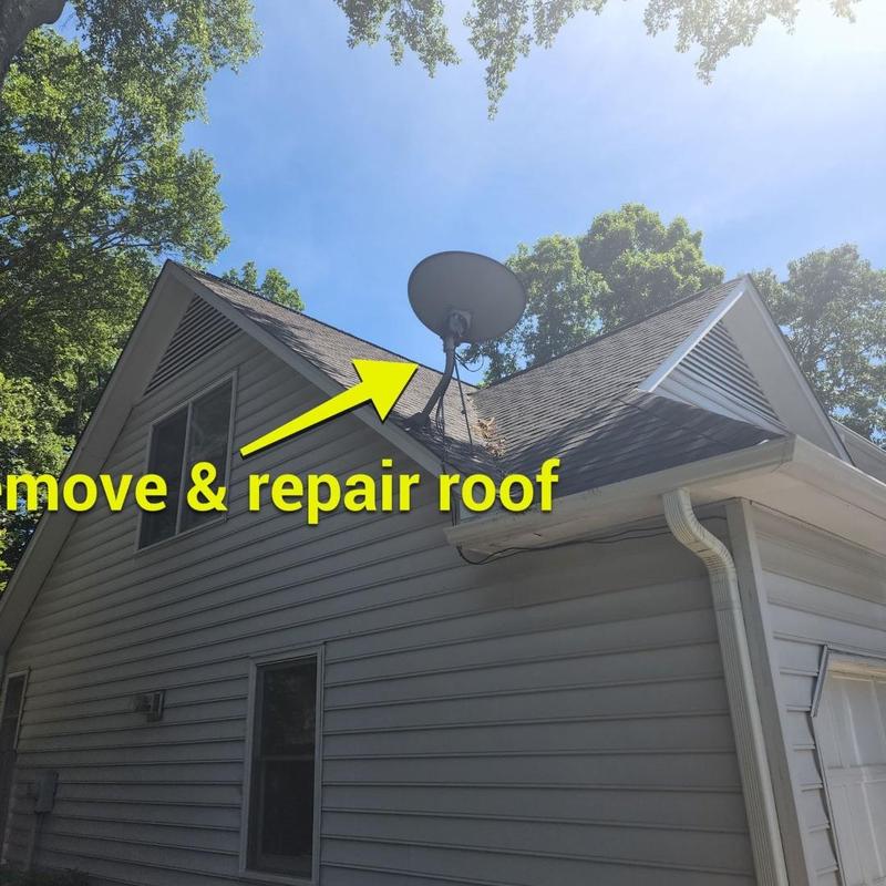 Roof shingles near satellite dish with storm damage