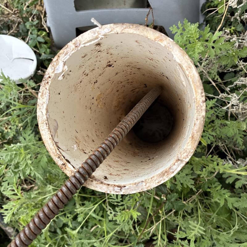 Sewer cleanout pipe with auger cable clearing blockage