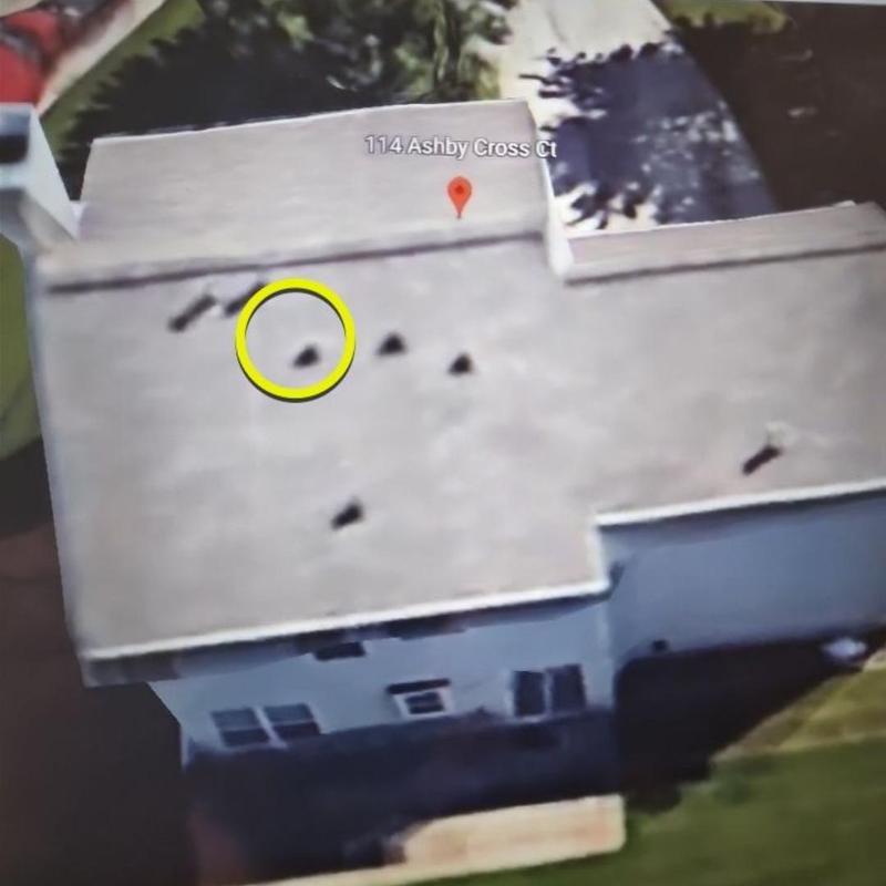 Roofing shingles with damage marked on aerial view