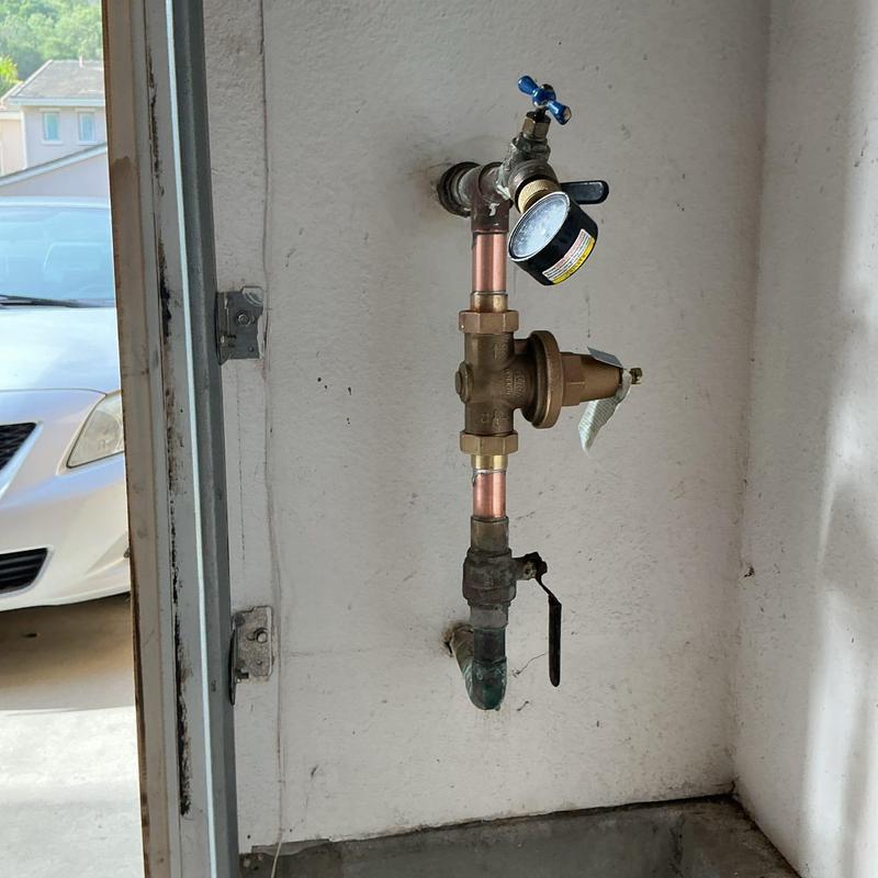 Pressure regulator and meter on main water riser