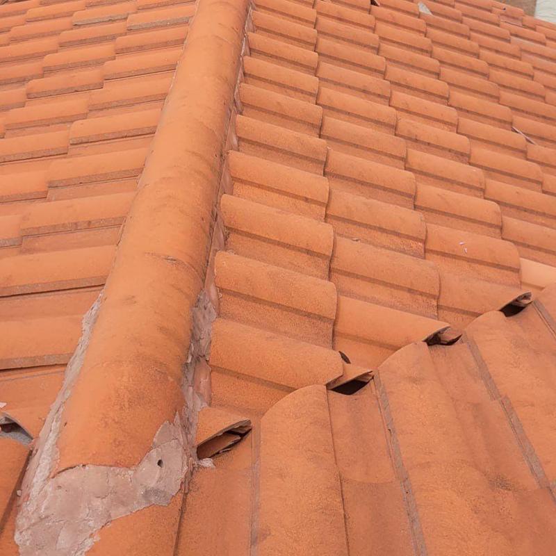 Concrete tile roof with replaced cap tiles