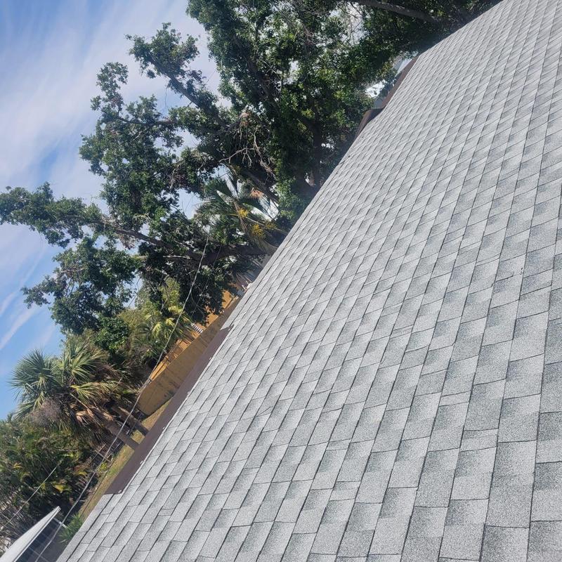 Shingle roof with repaired damage after tarp removal