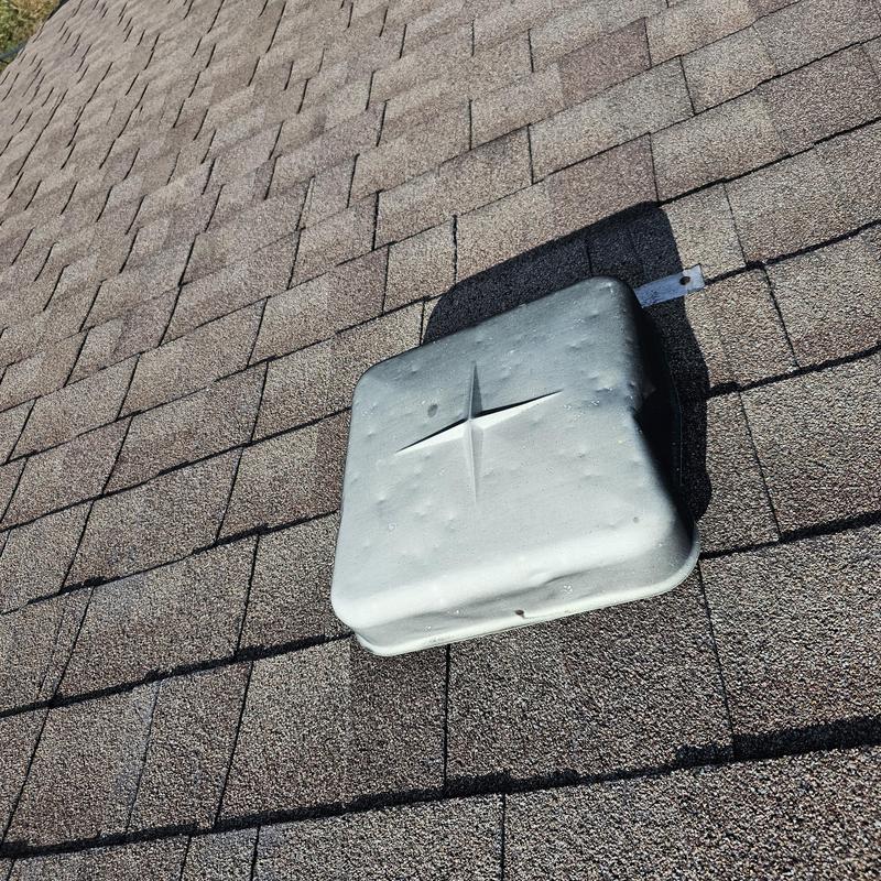 Roof vent with hail damage on asphalt shingles