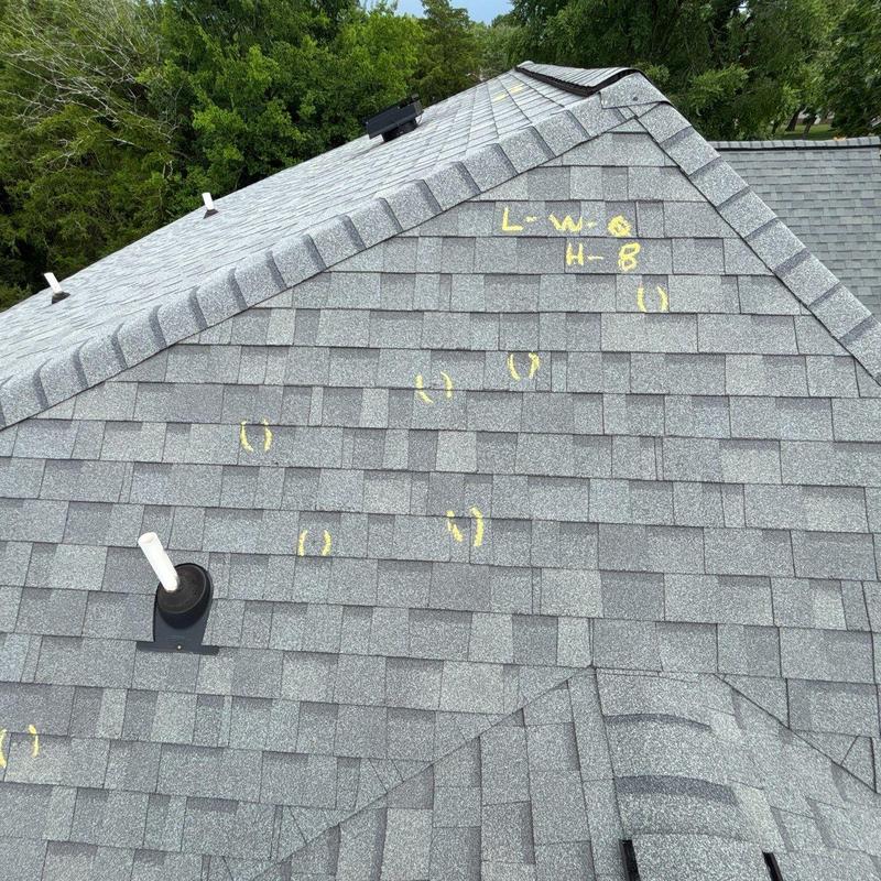 Asphalt shingle roof with hail damage markings