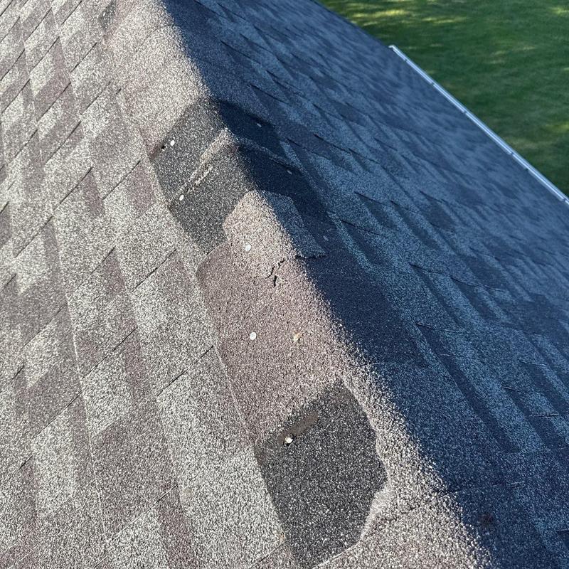 Roof shingles with hail damage and granule loss