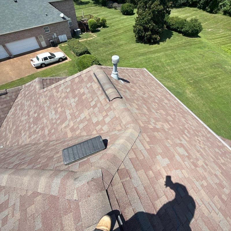 Asphalt shingle roof with ridge vent and vent pipe