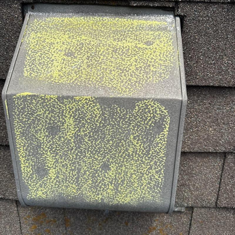 Metal roof vent with hail damage marked in yellow