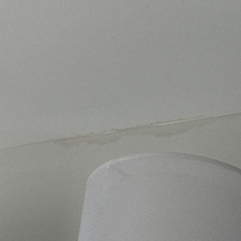 Water-stained ceiling crack near light fixture