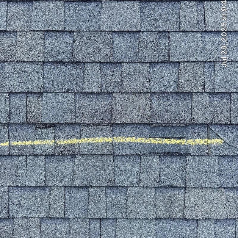 Asphalt shingle roof with hail damage markings