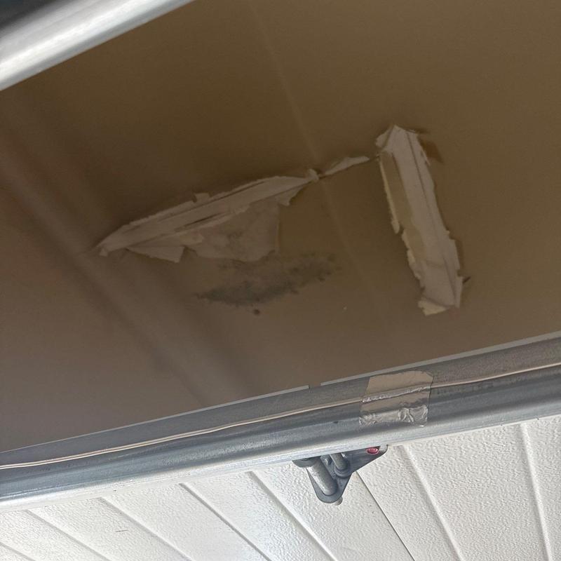 Garage ceiling drywall with water damage and peeling paint