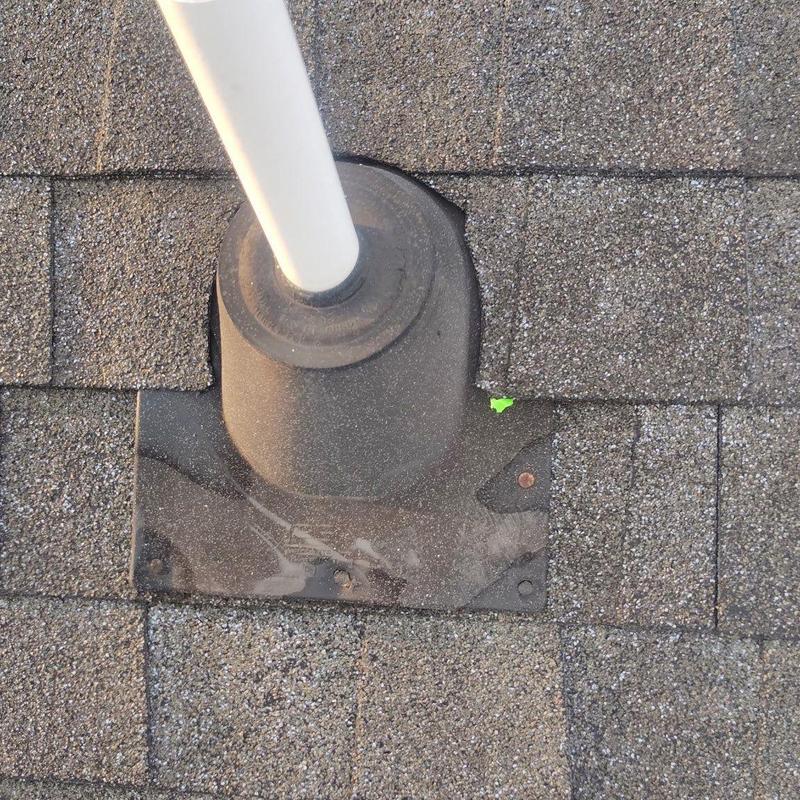Roof pipe flashing on damaged asphalt shingles