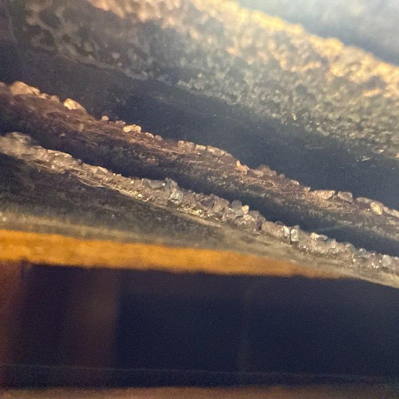 Roof shingle edges with hail damage close-up view