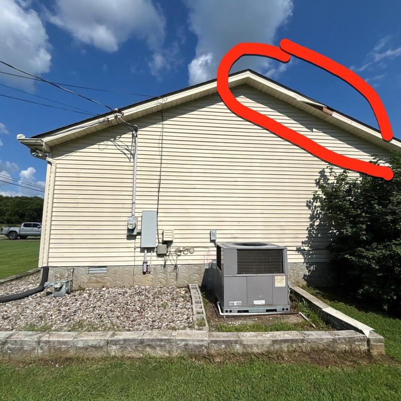 Roof ridge with visible damage circled in red