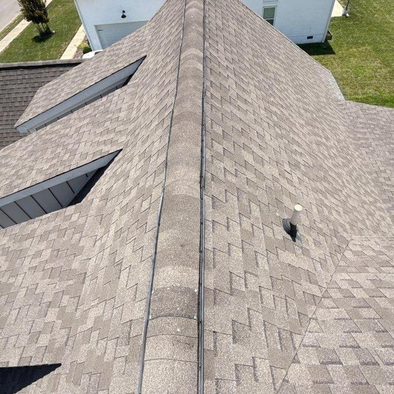 Asphalt shingle roof ridge and ventilation pipe inspection