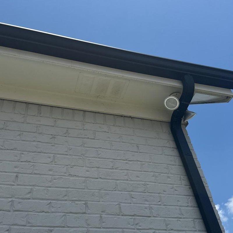 Roof ventilation vent installed under eaves near gutter