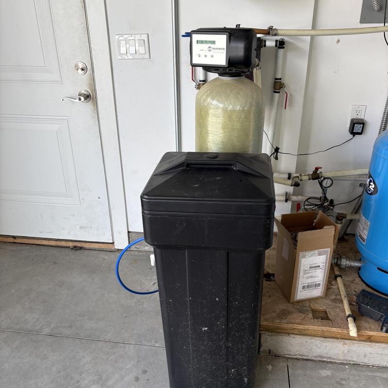 Water softener system installed in garage corner Water softener system installed in garage corner