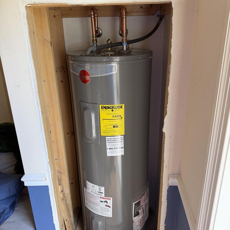 Electric water heater installed in closet with new valves