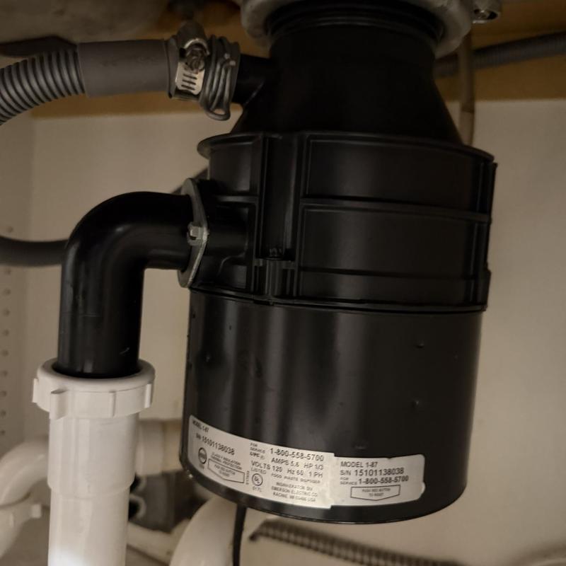 Garbage disposal unit under sink with plumbing connections