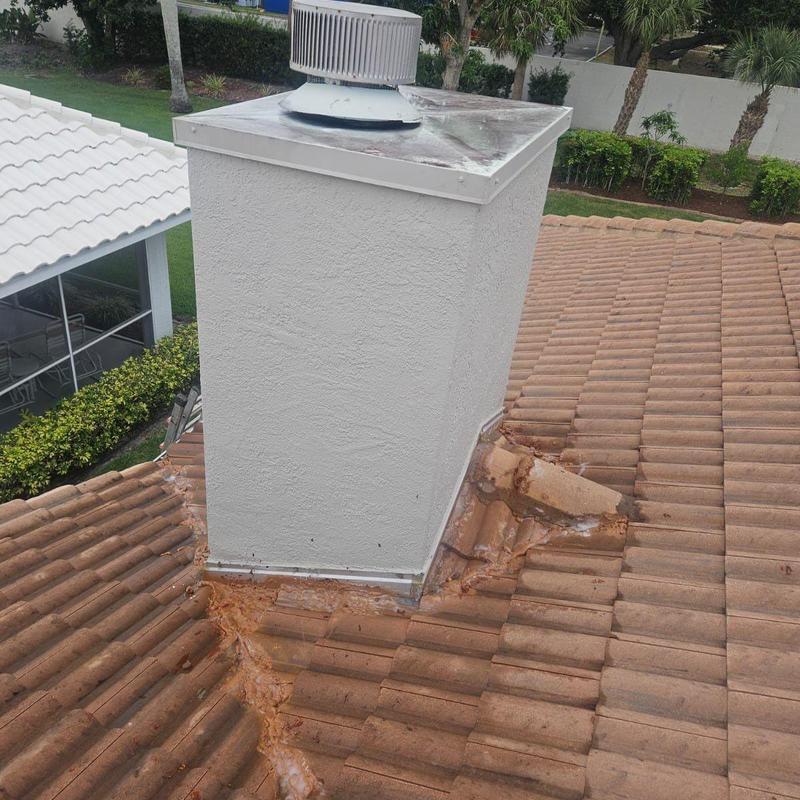 Chimney flashing with improper silicone sealant on tile roof