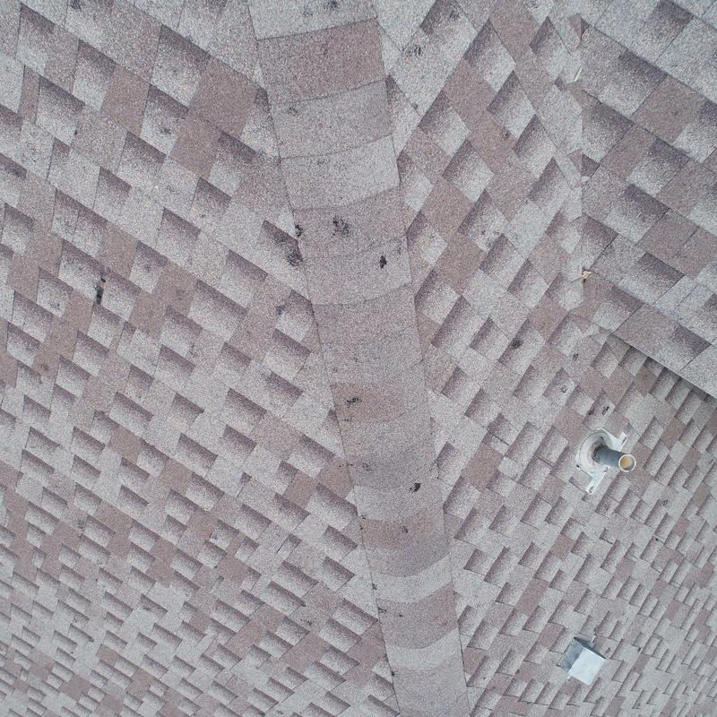 Asphalt shingle roof with hail damage close-up Asphalt shingle roof with hail damage close-up