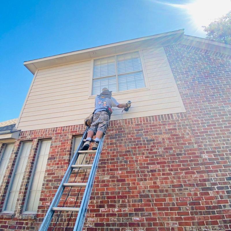LP SmartSide siding installation above brick wall