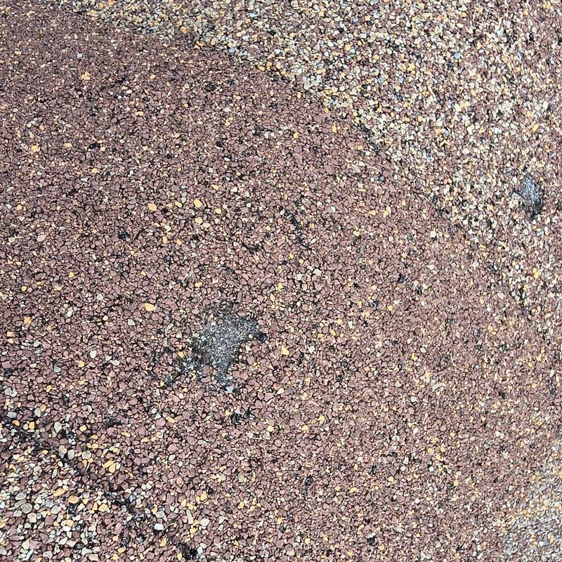 Asphalt shingle roofing with visible hail damage spots