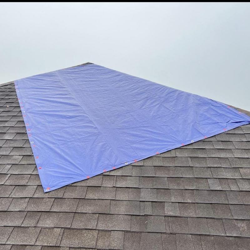 Roof ridge tarp installed for leak protection