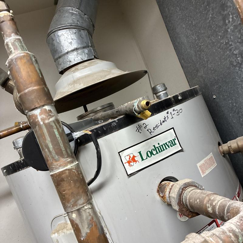 Water heater vent pipe and flue system near roof