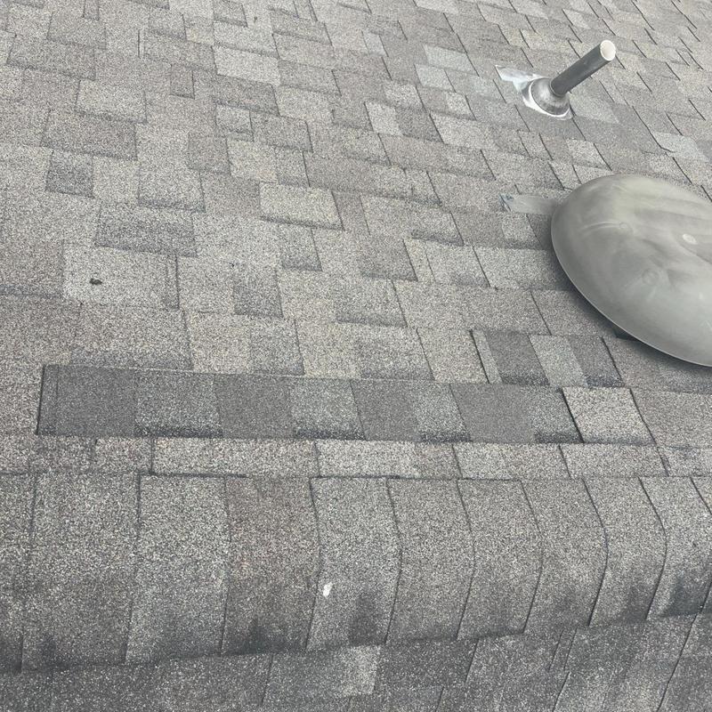 Roof shingles with vent stack and flashing sealing