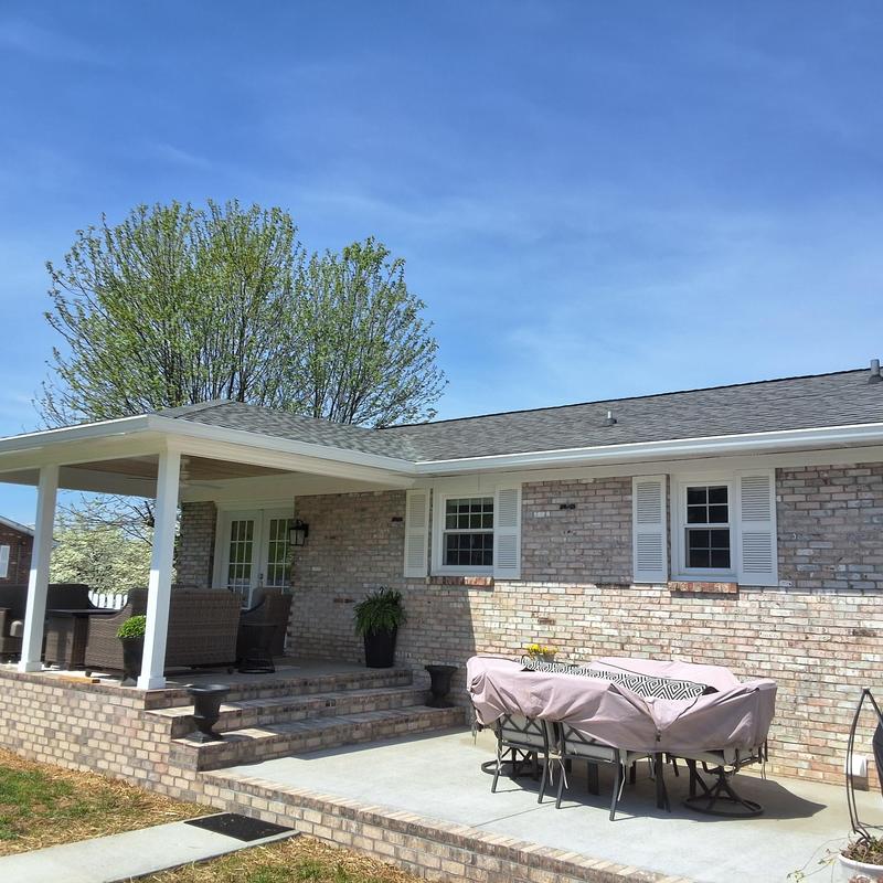 Asphalt shingle roof on brick home with covered porch