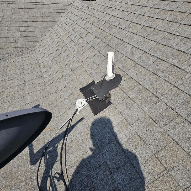 Roof vent pipe with hail damage on shingles