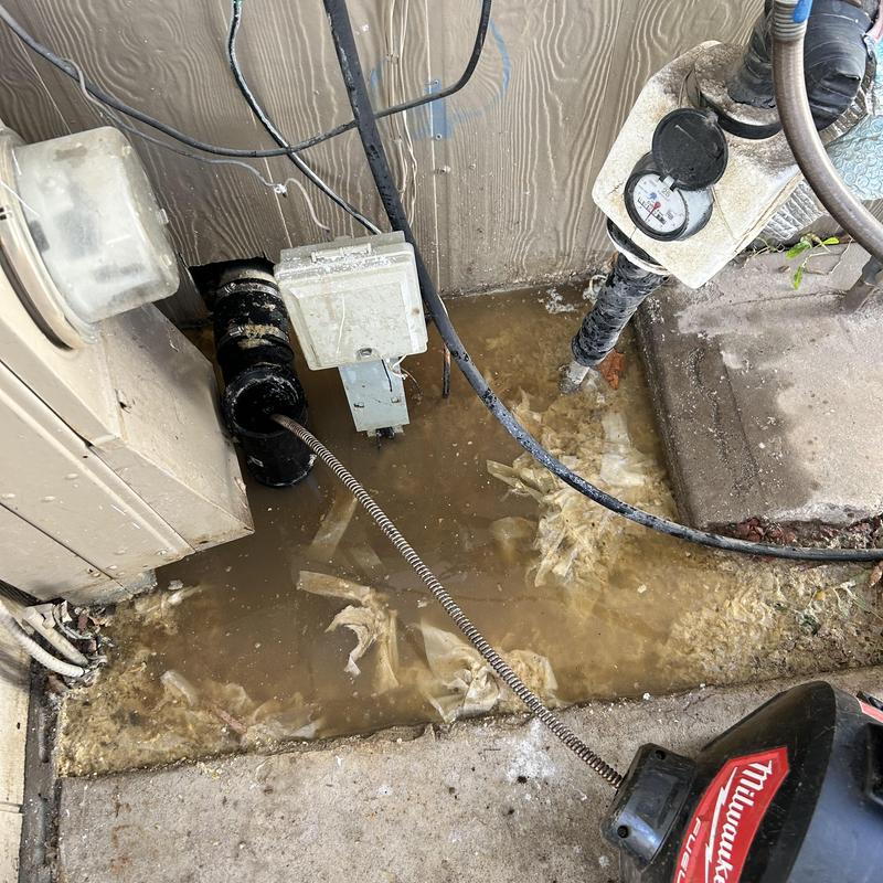 Main building drain clogged with wipes and water overflow