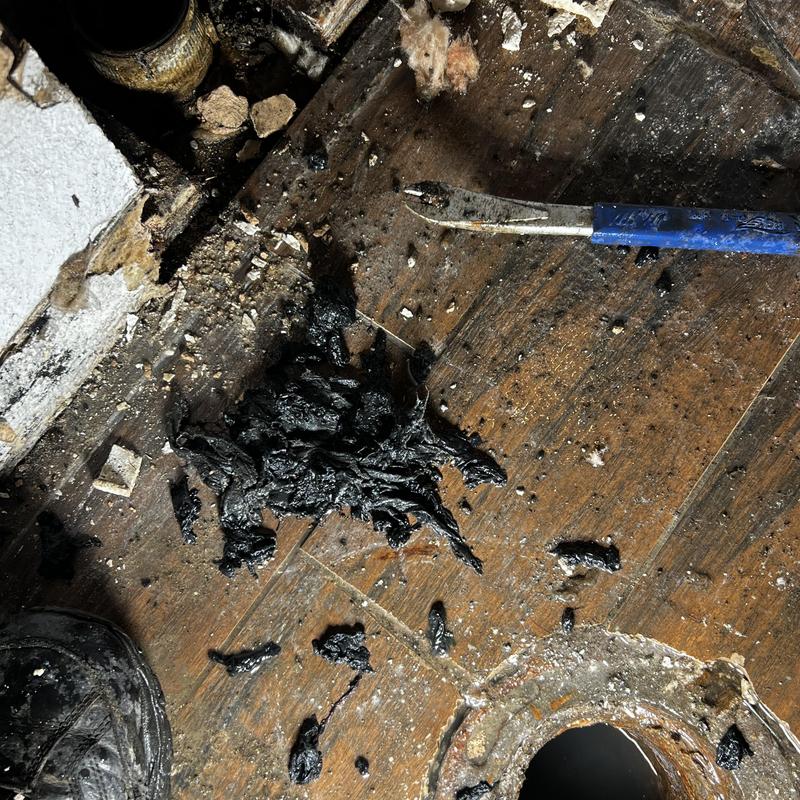 Toilet vent pipe clogged with debris on wooden floor Toilet vent pipe clogged with debris on wooden floor