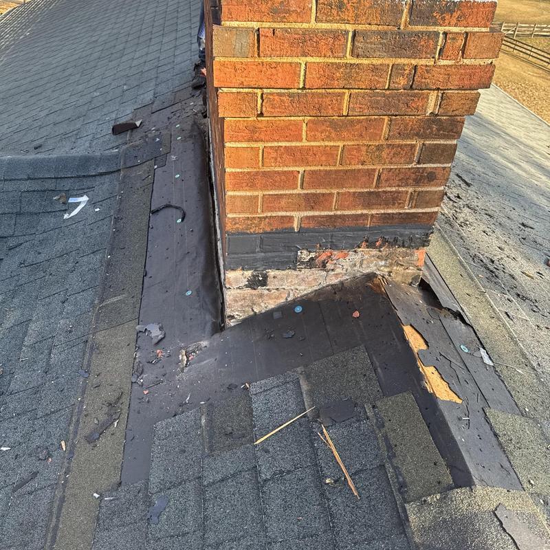 Masonry chimney flashing with damaged shingles