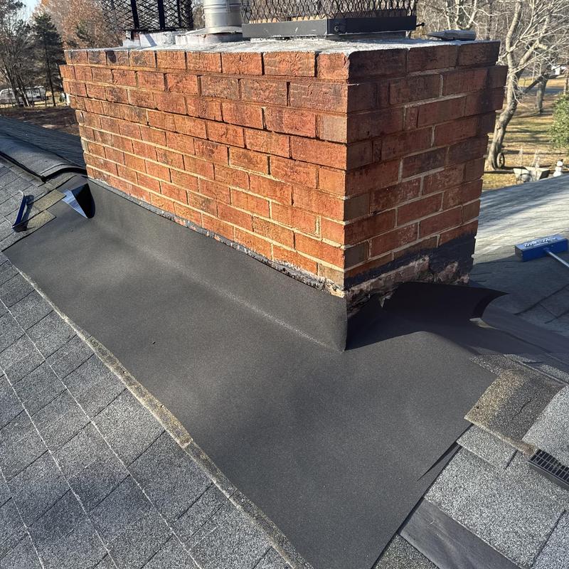 Masonry chimney reflash with ice and water shield on roof