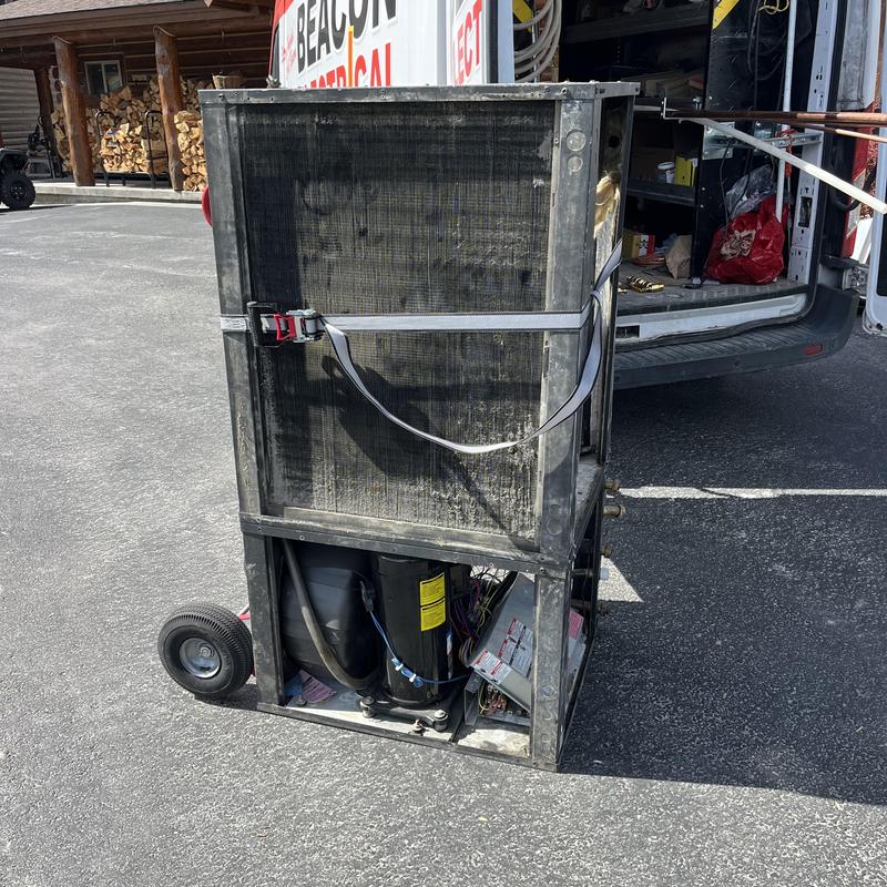 5 ton geothermal heat pump unit on dolly next to van